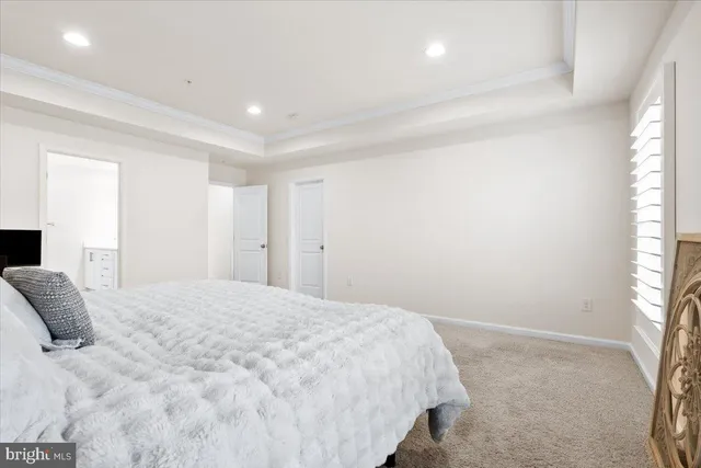 a large white bed in a white room