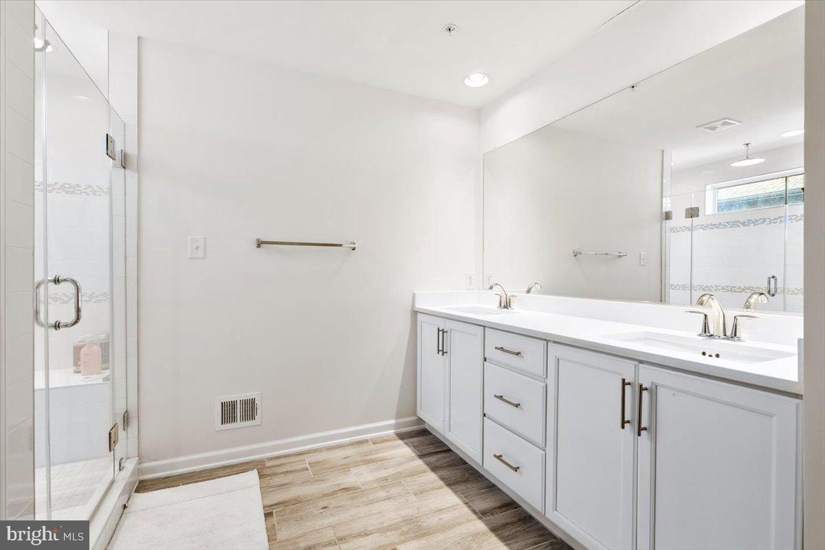 6828 West Shavano Road New Market, MD 21774 - Photo 29 of 58 a spacious bathroom with a double vanity sink a mirror and a shower