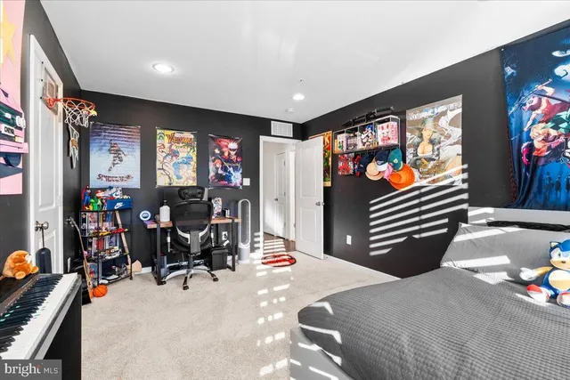 a bedroom with furniture and a flat screen tv