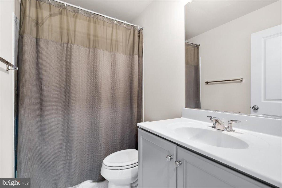 6828 West Shavano Road New Market, MD 21774 - Photo 36 of 58 a bathroom with a sink a toilet and a mirror