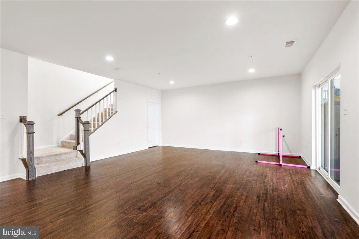 6828 West Shavano Road New Market, MD 21774 - Photo 39 of 58 a view of empty room with wooden floor and fan