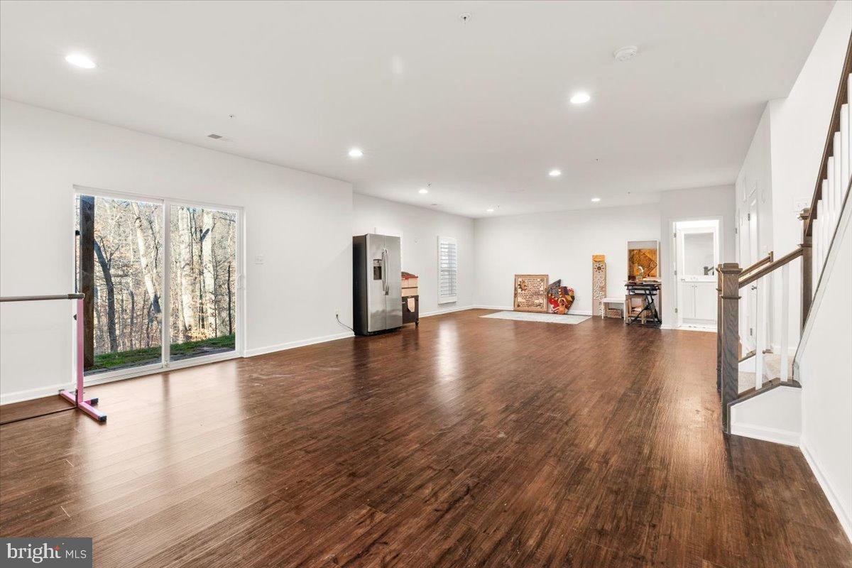6828 West Shavano Road New Market, MD 21774 - Photo 40 of 58 a view of a hall with wooden floor and a large window