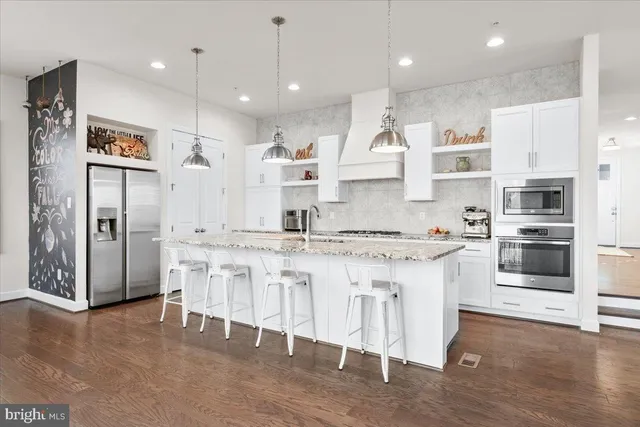 a large kitchen with cabinets and stainless steel appliances