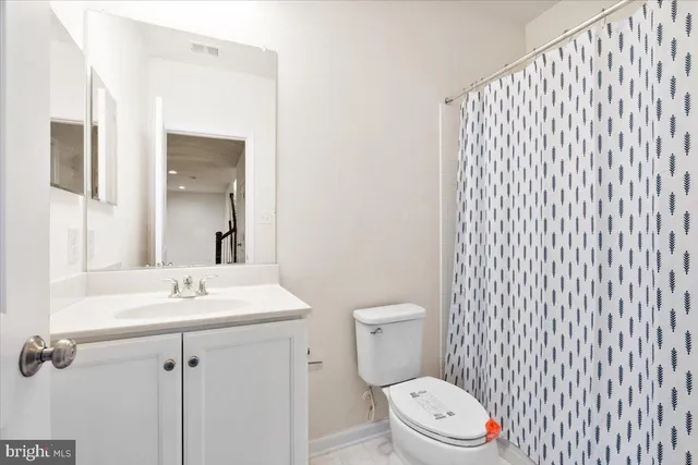 a white toilet sitting next to a white sink