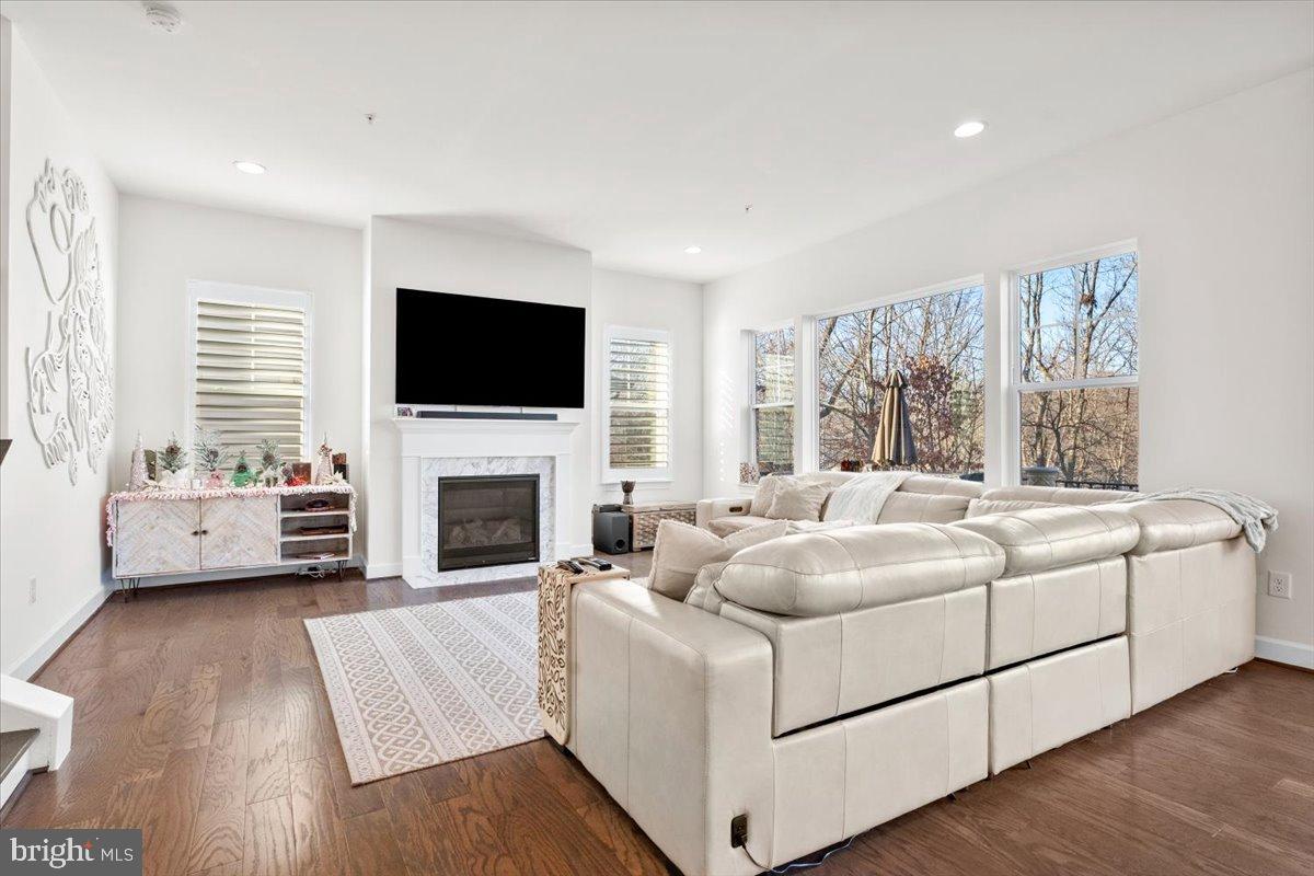 6828 West Shavano Road New Market, MD 21774 - Photo 6 of 58 a living room with furniture a fireplace and a flat screen tv