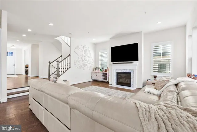 a living room with fireplace a flat screen tv and a fireplace