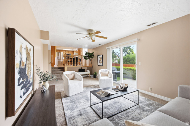 734 Sandy Dunes Drive Sandy, UT 84094 - Photo 13 of 36 Living area featuring neutral wall tones, textured ceiling, a ceiling fan, and carpeted flooring