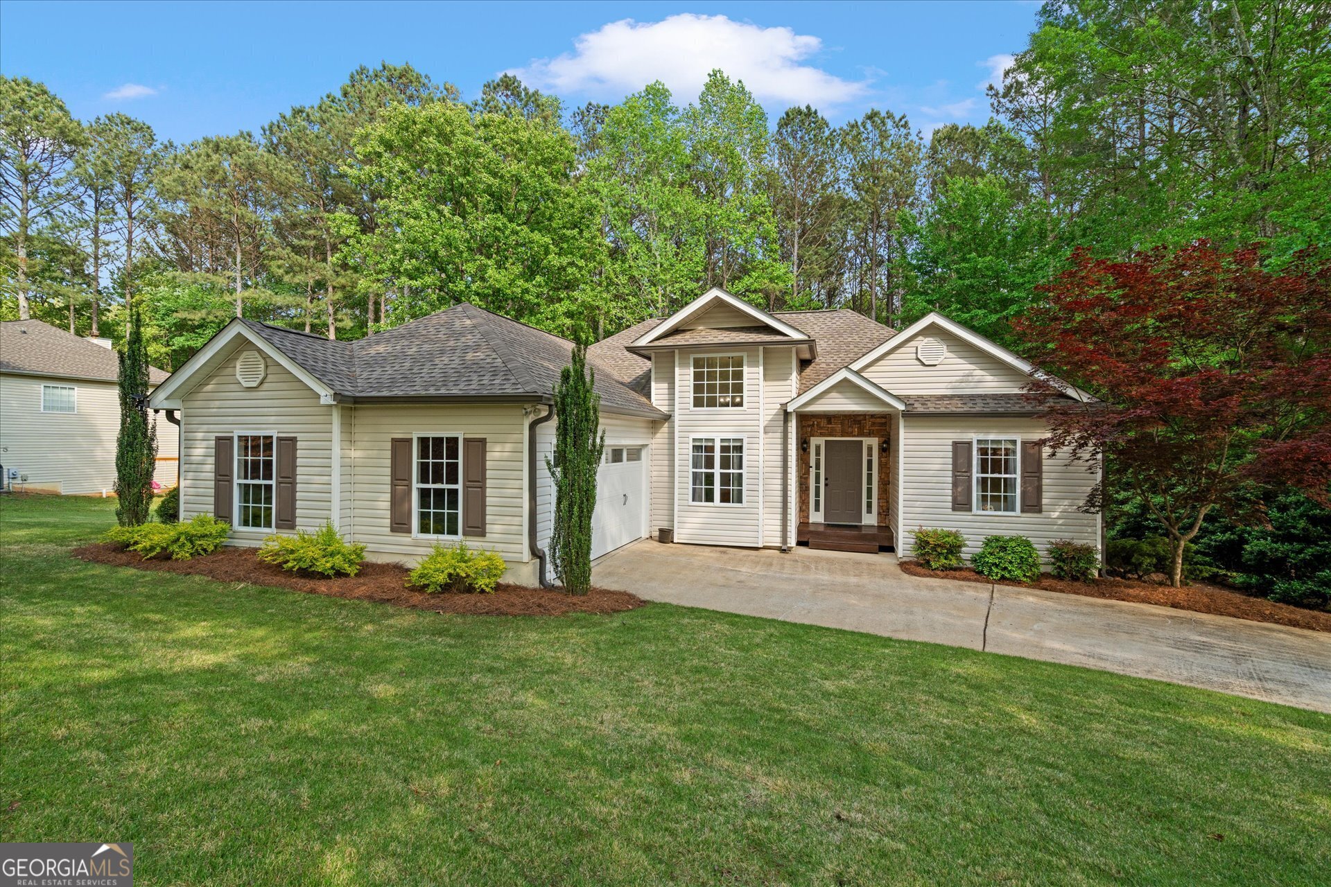 2698 Pleasant Grove Church Road Villa Rica, GA 30180 - Photo 1 of 1 a front view of a house with a yard and trees