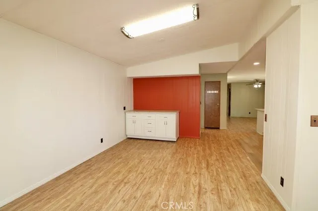 a view of an empty room and wooden floor