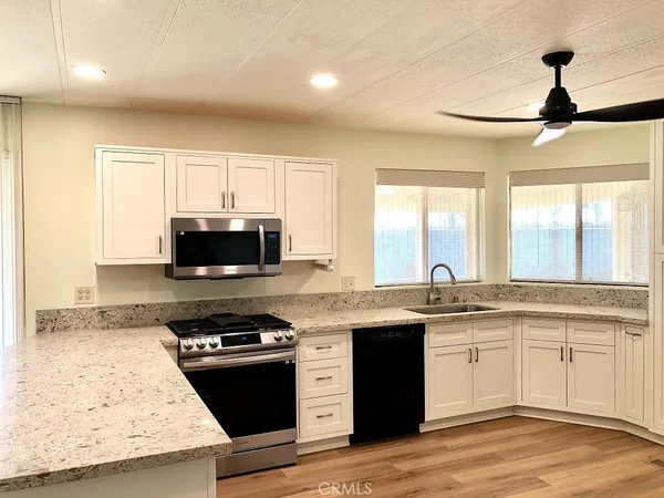 a kitchen with stainless steel appliances granite countertop a stove and a sink
