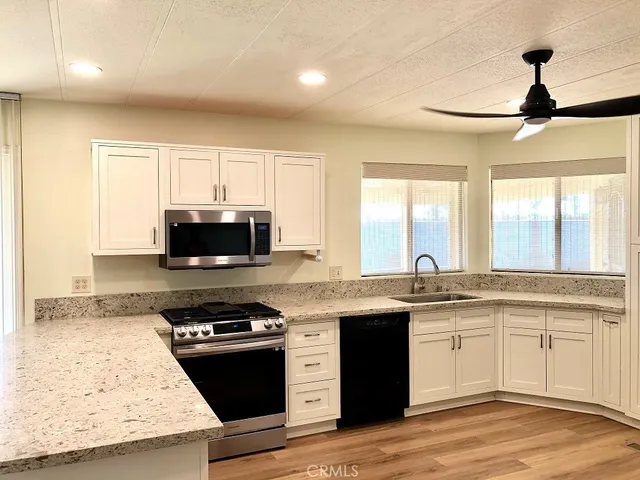 a kitchen with stainless steel appliances granite countertop a stove and a sink