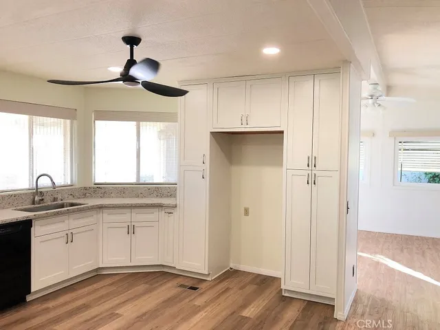 a view of a kitchen with a sink and wooden floor