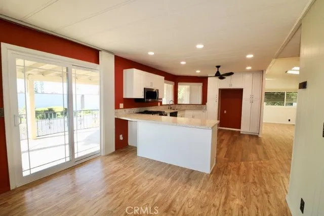 a view of kitchen with cabinets and wooden floor