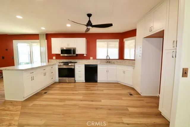 a kitchen with stainless steel appliances granite countertop a stove and a sink