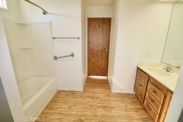 a bathroom with a tub sink a shower and a mirror