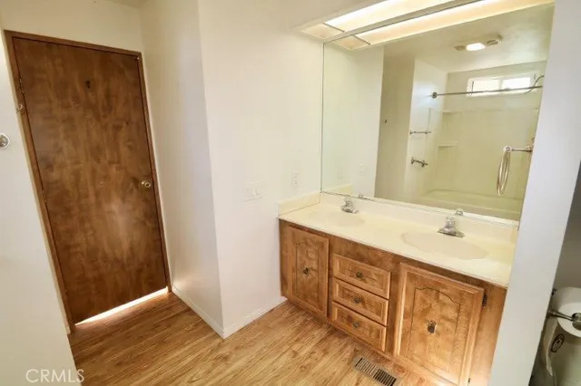 a bathroom with a sink a mirror and a shower