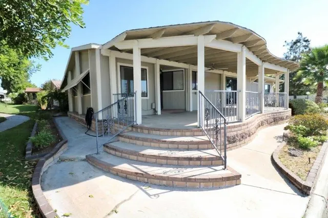 a view of a house with sitting area and garden