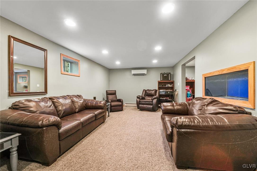 117 Mt Snow Road Henryville, PA 18332 - Photo 28 of 34 a living room with furniture ceiling fan and a flat screen tv