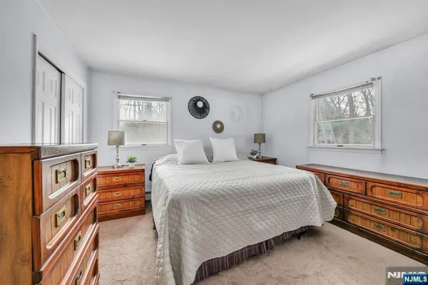 a bedroom with bed and window