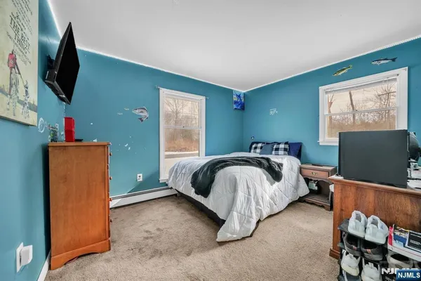 a bedroom with a bed and flat screen tv