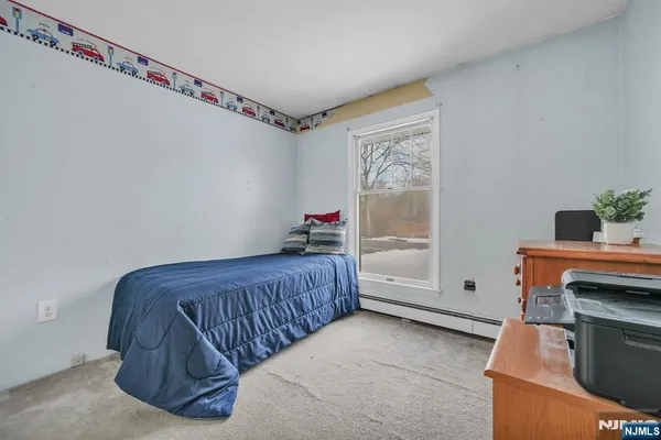 a bedroom with furniture and a window