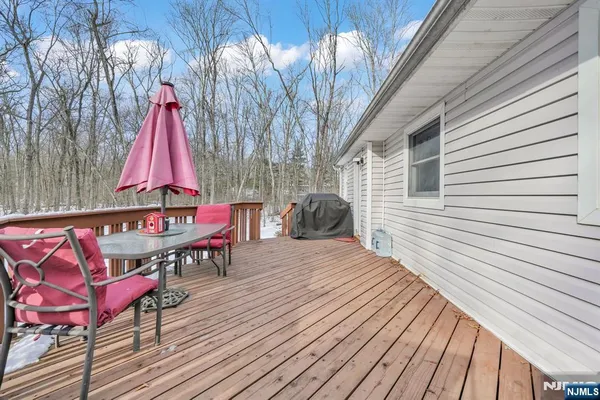 a view of a chairs and table on the wooden deck