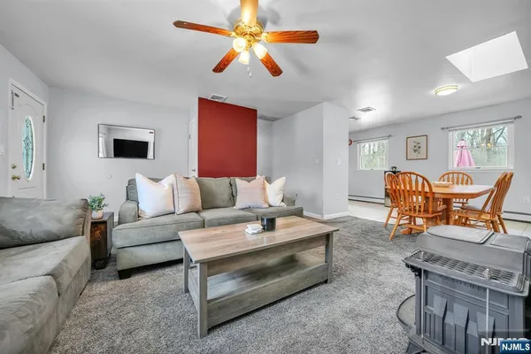 a living room with furniture and a chandelier
