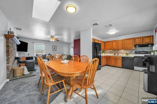 a view of a dining room with furniture and a kitchen