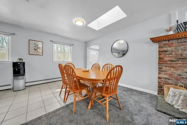 a dining room with furniture and window