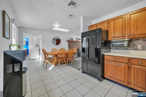 a kitchen with stainless steel appliances granite countertop a refrigerator and wooden cabinets