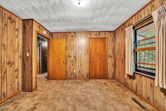 a spacious bedroom with a large bed and a window