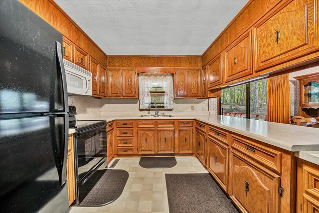 a kitchen with sink cabinets and window