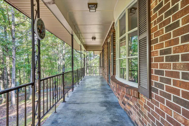 an empty room with windows and fireplace