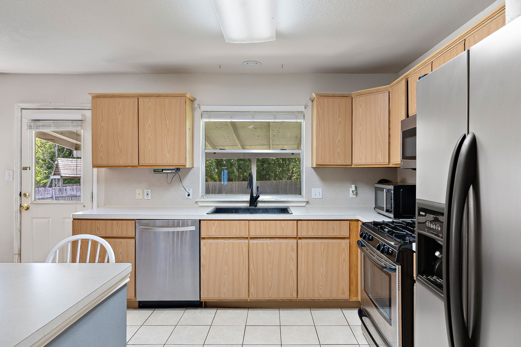 615 Runners Ridge Pflugerville, TX 78660 - Photo 10 of 32 a kitchen with a sink stove and refrigerator