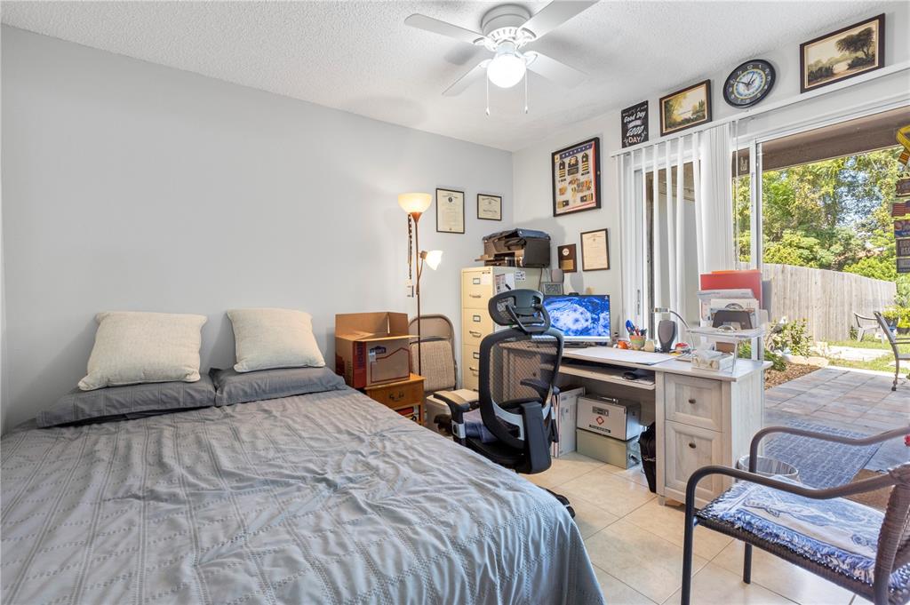 22751 Penny Loop Land O' Lakes, FL 34639 - Photo 14 of 27 a bedroom with a bed and a desk