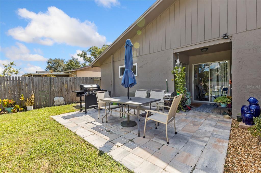 22751 Penny Loop Land O' Lakes, FL 34639 - Photo 16 of 27 a view of a patio with table and chairs and potted plants