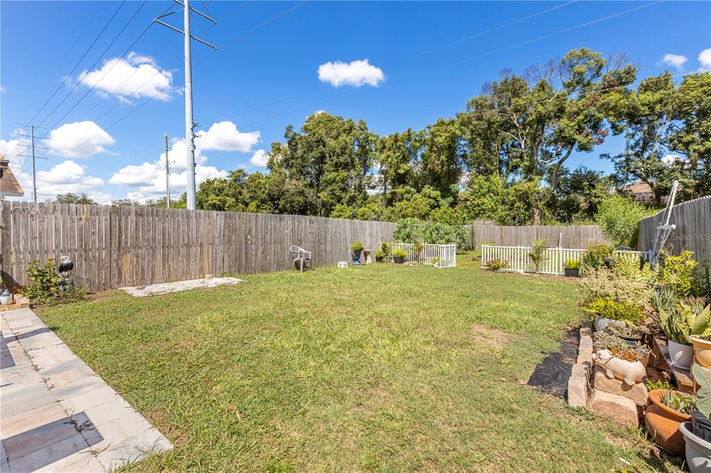22751 Penny Loop Land O' Lakes, FL 34639 - Photo 19 of 27 a backyard of a house with table and chairs