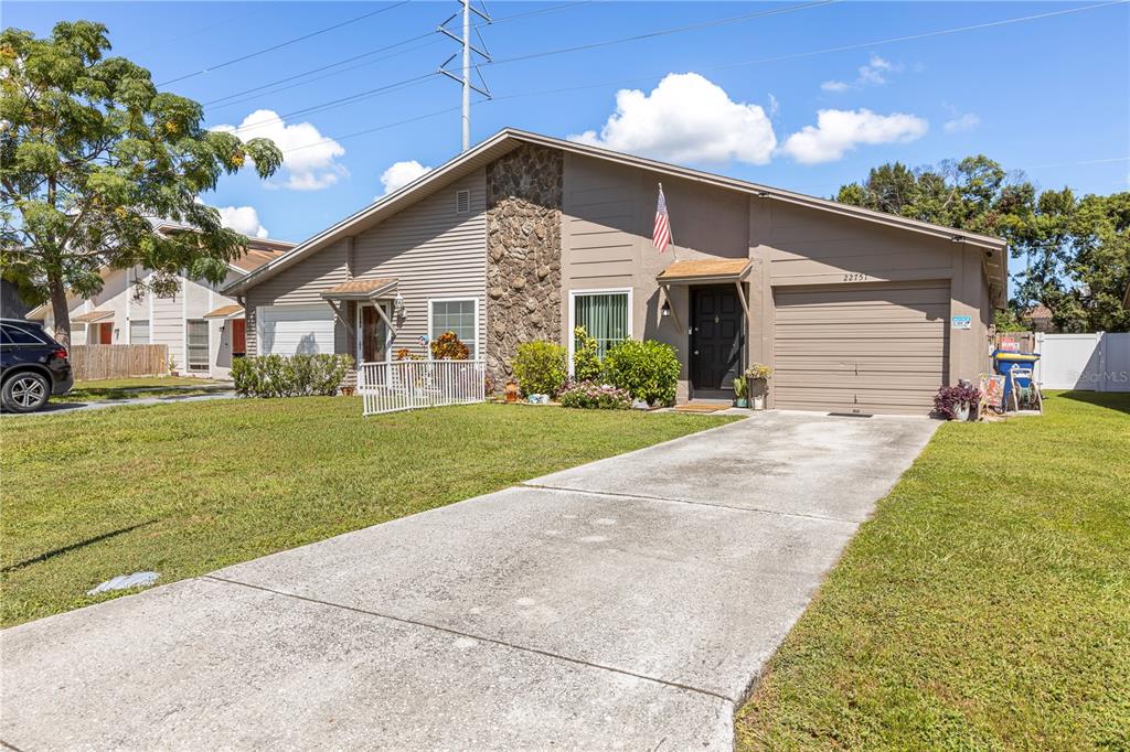 22751 Penny Loop Land O' Lakes, FL 34639 - Photo 2 of 27 a front view of house with yard