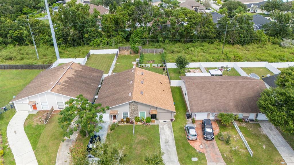 22751 Penny Loop Land O' Lakes, FL 34639 - Photo 25 of 27 an aerial view of a house with pool a patio and yard