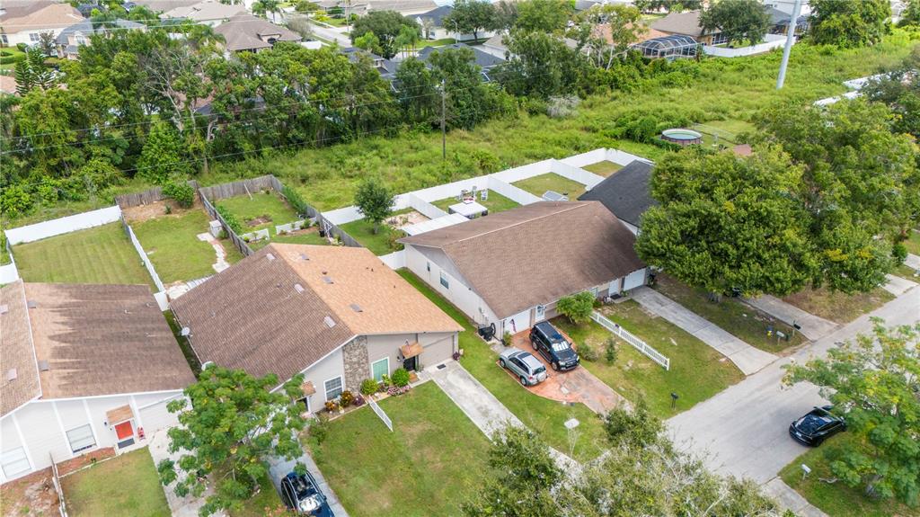 22751 Penny Loop Land O' Lakes, FL 34639 - Photo 26 of 27 an aerial view of a house with a yard and lake
