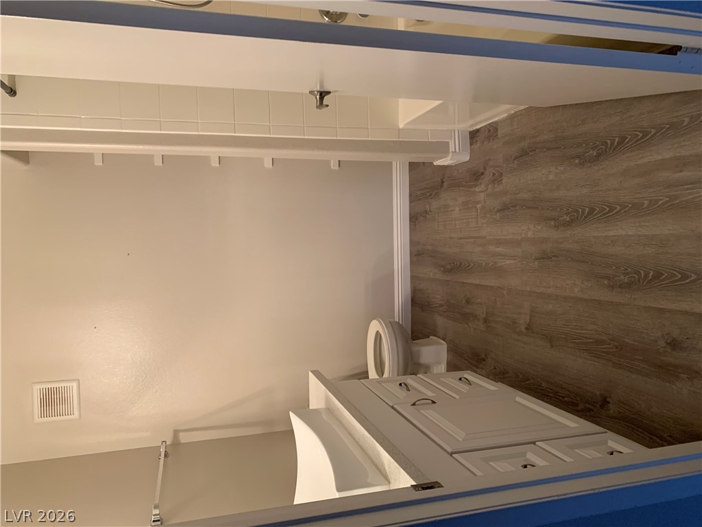 7885 West Flamingo Road, Unit 1003 Las Vegas, NV 89147 - Photo 7 of 7 A compact bath features wood-look flooring and a functional vanity with panel detailing.