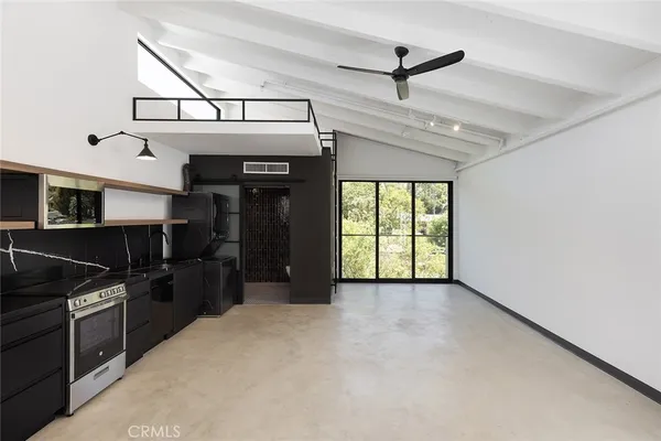a kitchen with kitchen island a counter top space and stainless steel appliances