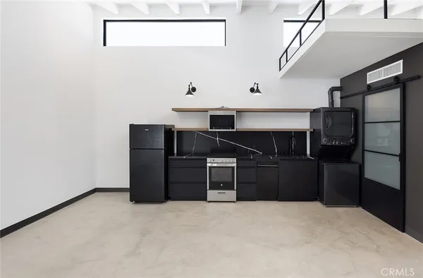a view of a utility room with cabinets