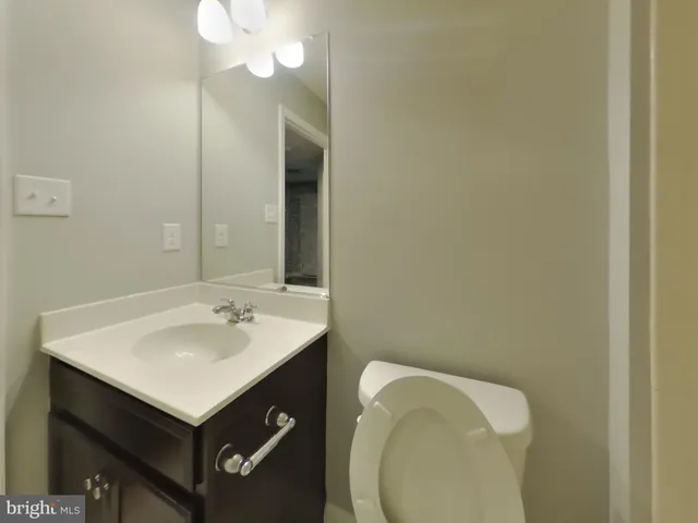 a bathroom with a sink vanity and mirror