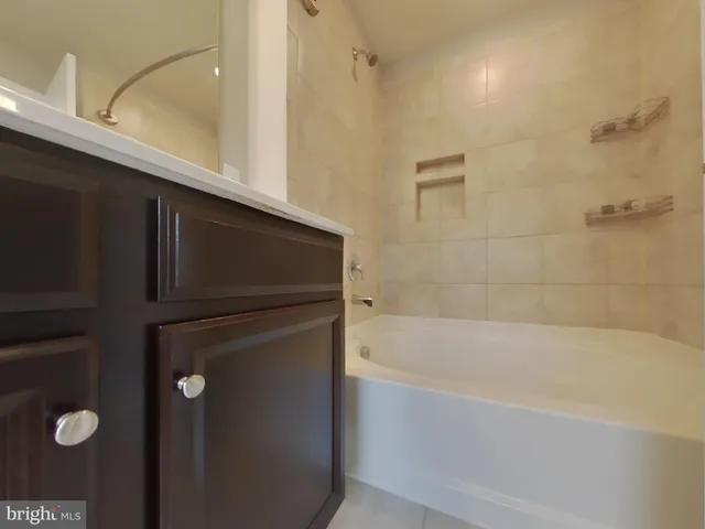 a bathroom with a bathtub and shower