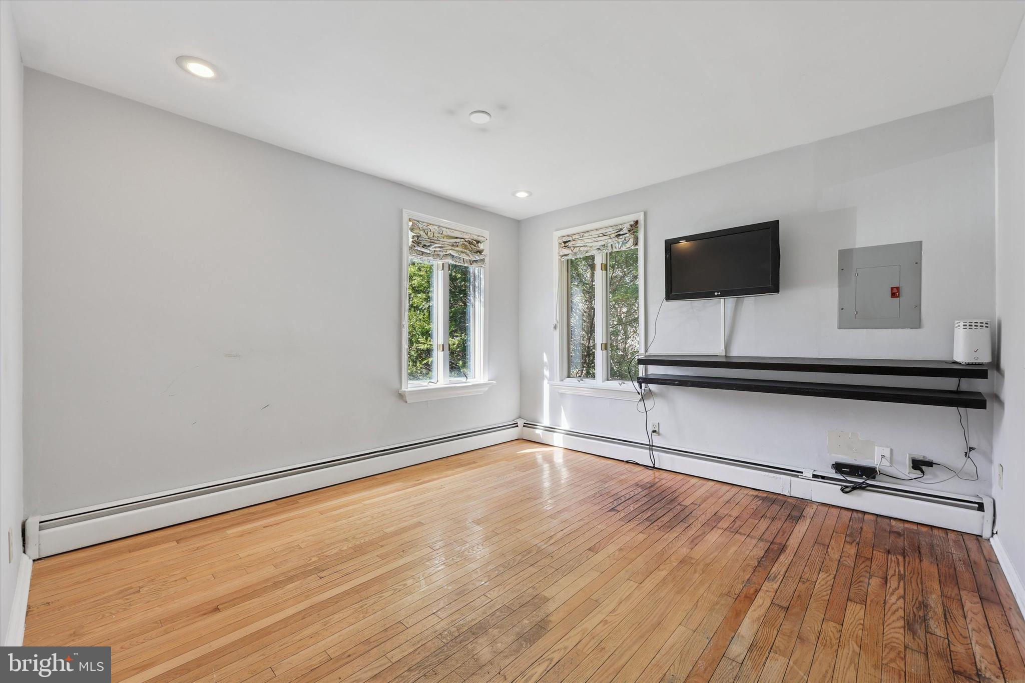 13 Devonwood Road Wayne, PA 19087 - Photo 14 of 24 a living room with hardwood floor and flat screen tv