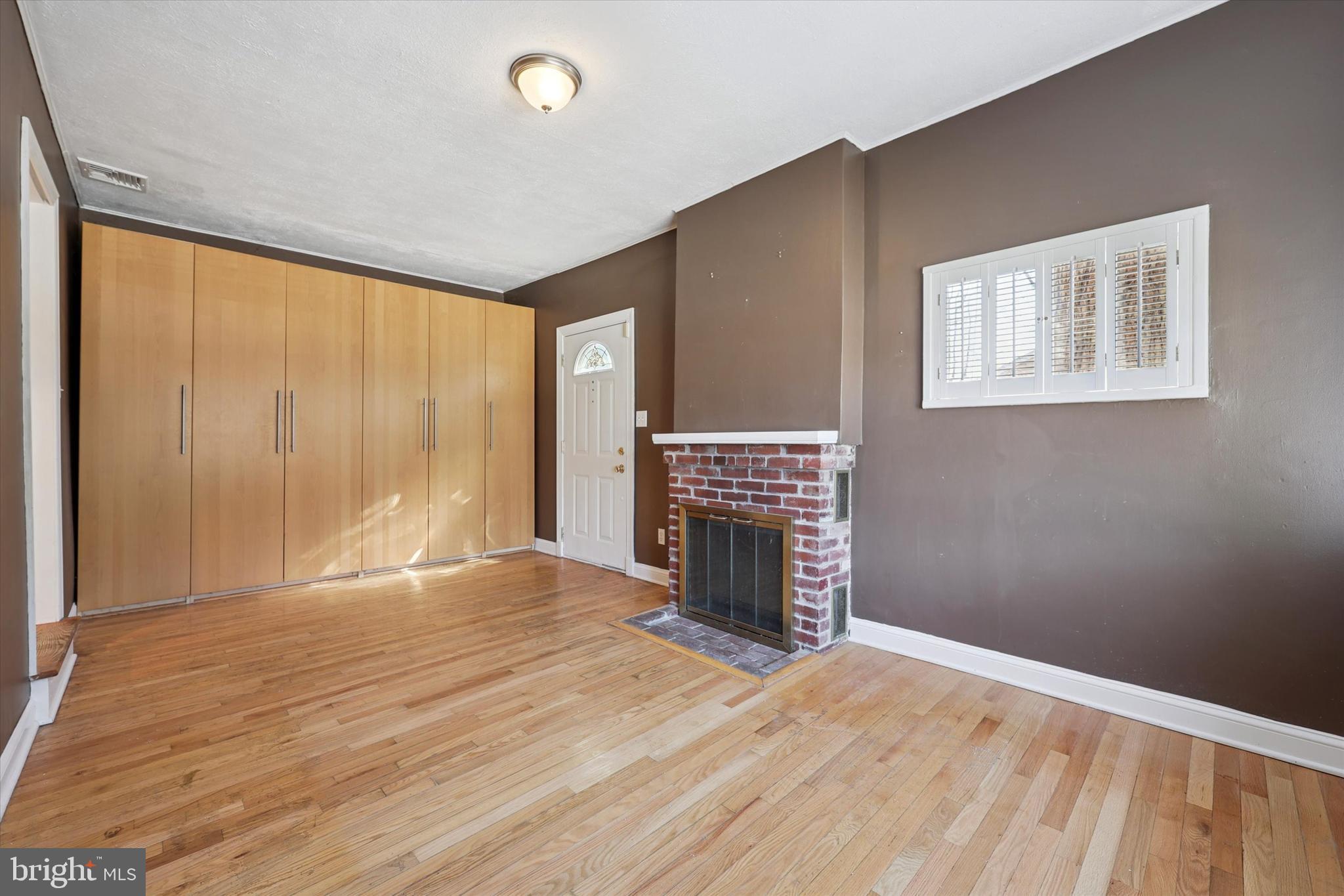 13 Devonwood Road Wayne, PA 19087 - Photo 3 of 24 a view of empty room with fireplace and wooden floor