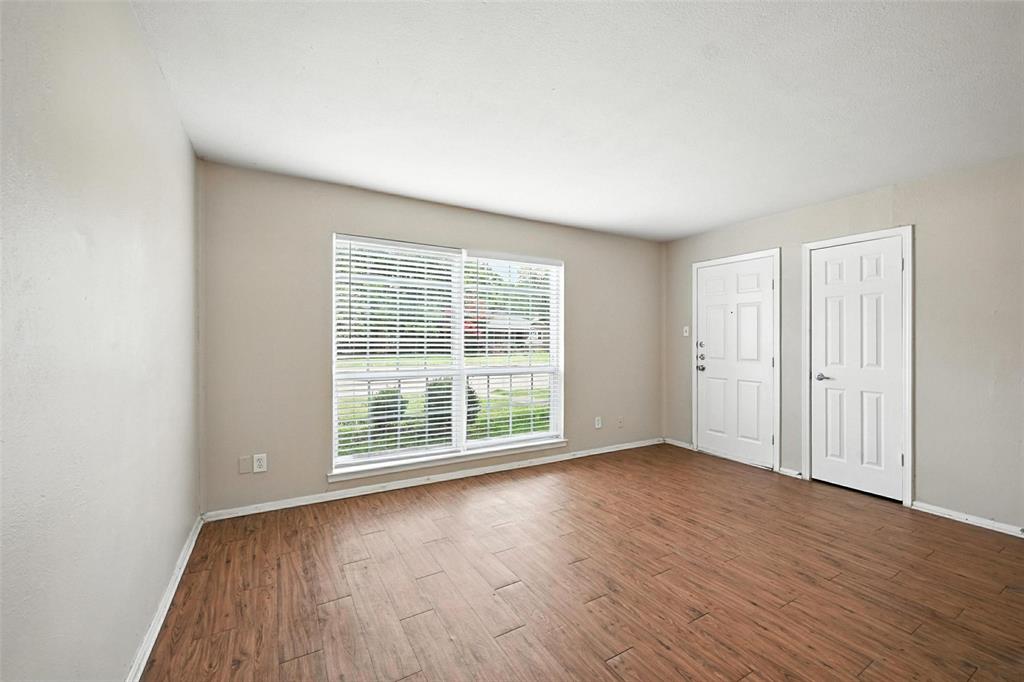 103 West Brown Street, Unit 5 Wylie, TX 75098 - Photo 11 of 24 an empty room with wooden floor and windows