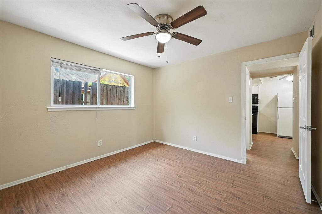103 West Brown Street, Unit 5 Wylie, TX 75098 - Photo 13 of 24 wooden floor in an empty room with a window