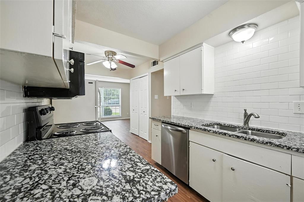 103 West Brown Street, Unit 5 Wylie, TX 75098 - Photo 5 of 24 a kitchen with a sink stove and cabinets